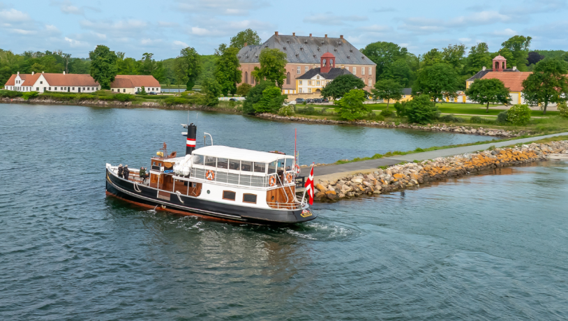 Den gamle færge MS Helge lægger til ved en stenkaj ud foran Valdemars Slot