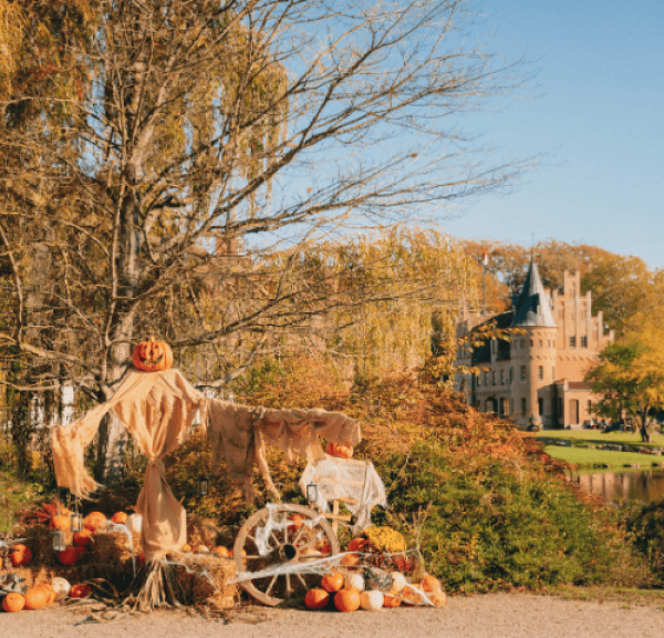 A halloween scarecrow in front of the old renaissance castle Egeskov on an autumn day